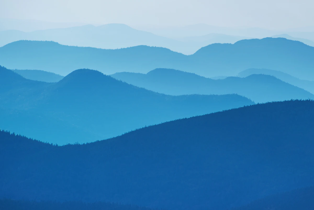 Layers of blue mountain ridges fading into haze